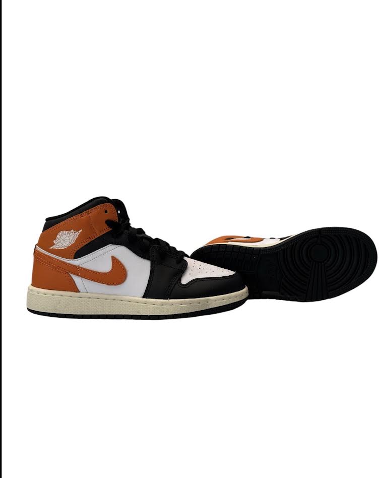 Black, orange, and white sneaker with a prominent logo on a white background