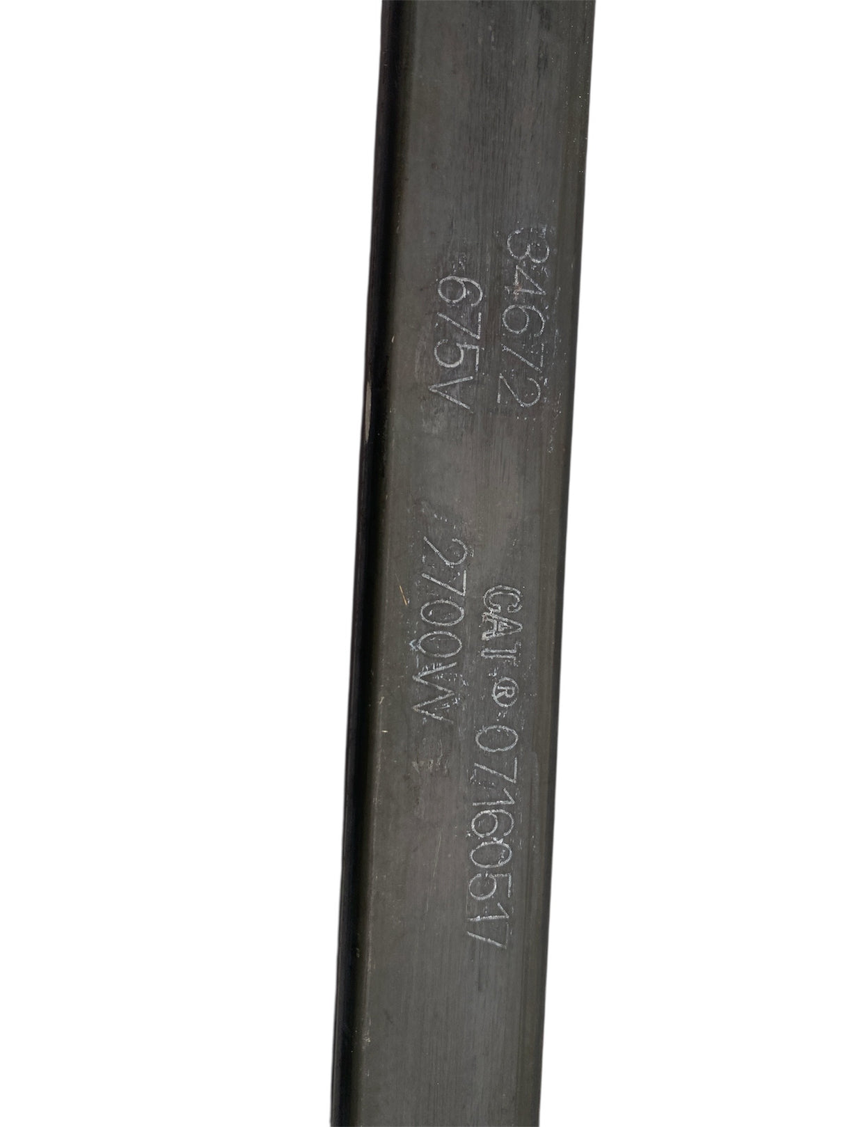 Close-up of a cylindrical metal component with engraved text on a white background