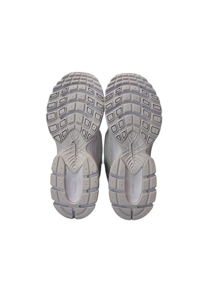 Pair of gray athletic shoes with tread pattern on a white background