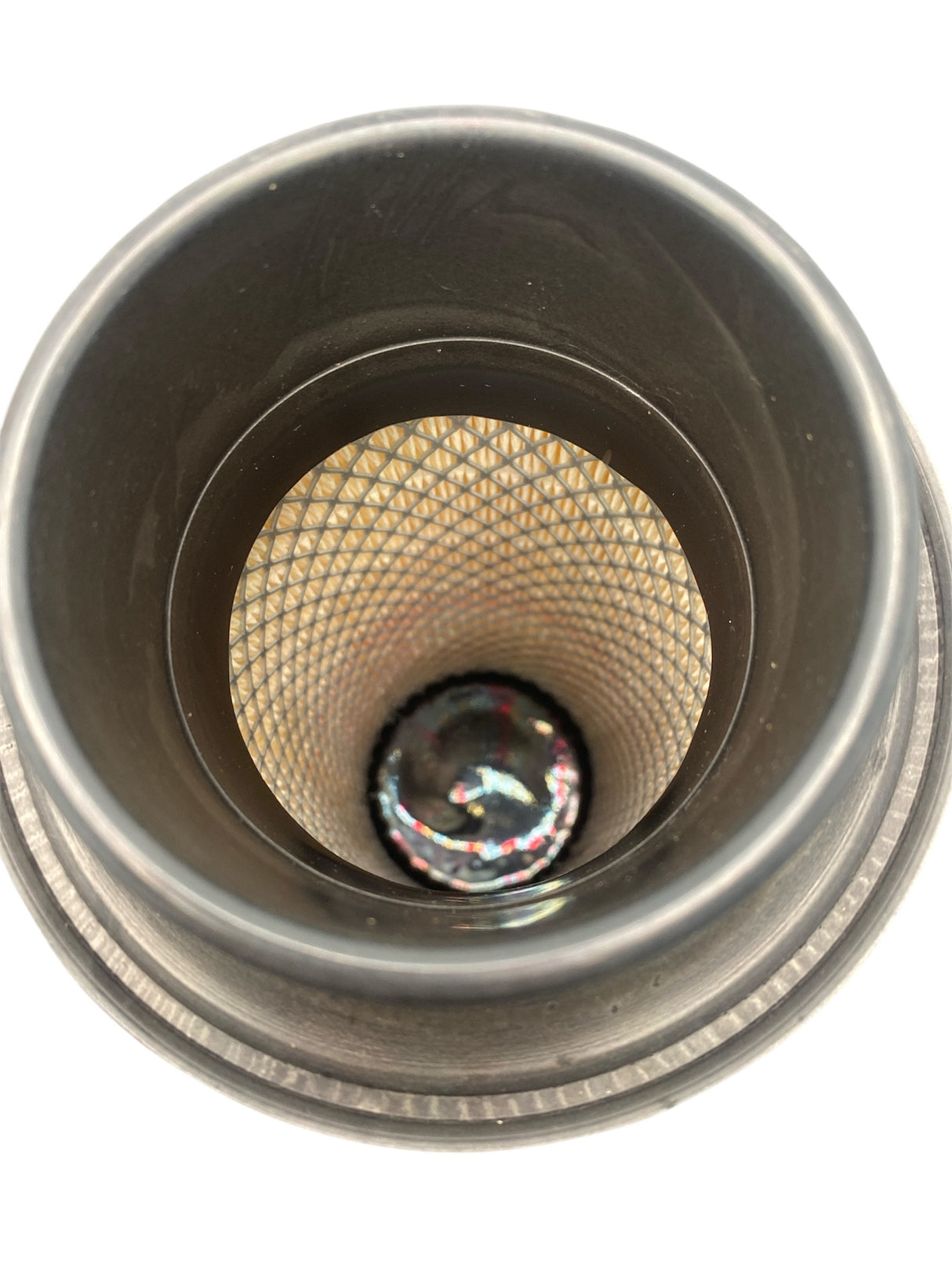 Close-up of a metallic object with textured interior on a white background