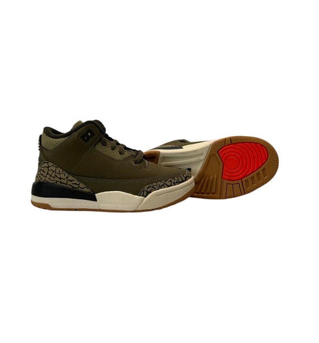 Pair of sneakers with a green, black, and brown color scheme on a white background