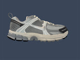 Gray athletic shoe on a dark blue background