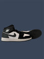 Black and white high-top sneaker on a dark blue background