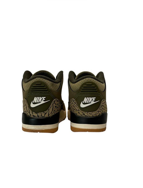 Pair of Nike sneakers with a camouflage pattern on a white background