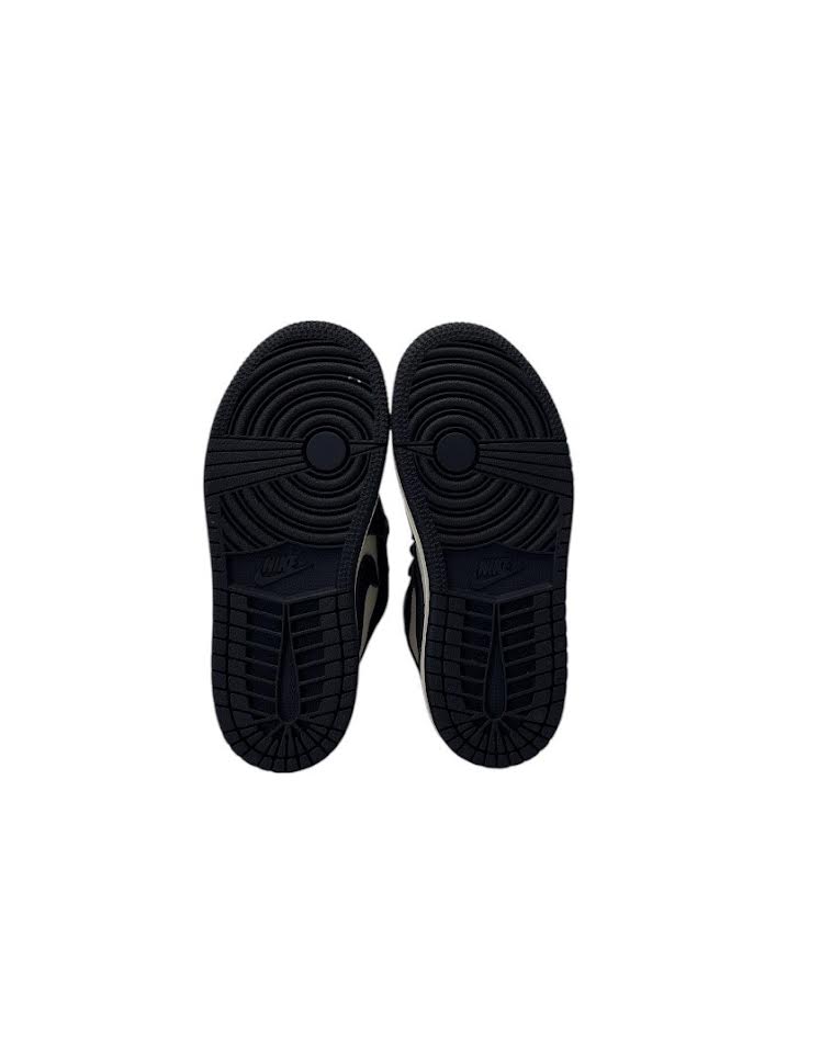 Black sneakers shown from the sole on a white background
