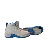 Pair of gray and blue sneakers on a white background