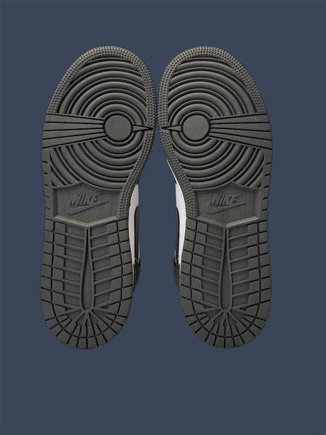 Close-up of a pair of Nike shoes with tread pattern on a dark blue background