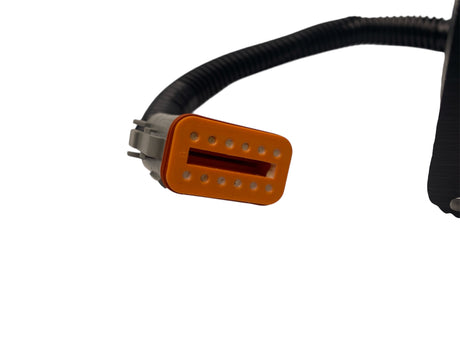Close-up of a guitar pickup with an orange casing on a white background