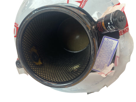 Close-up of a metal filter with visible text and labels on a white background