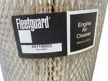 Fleetguard engine air cleaner with label on a white background