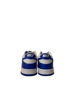 White sneakers with blue accents on a white background