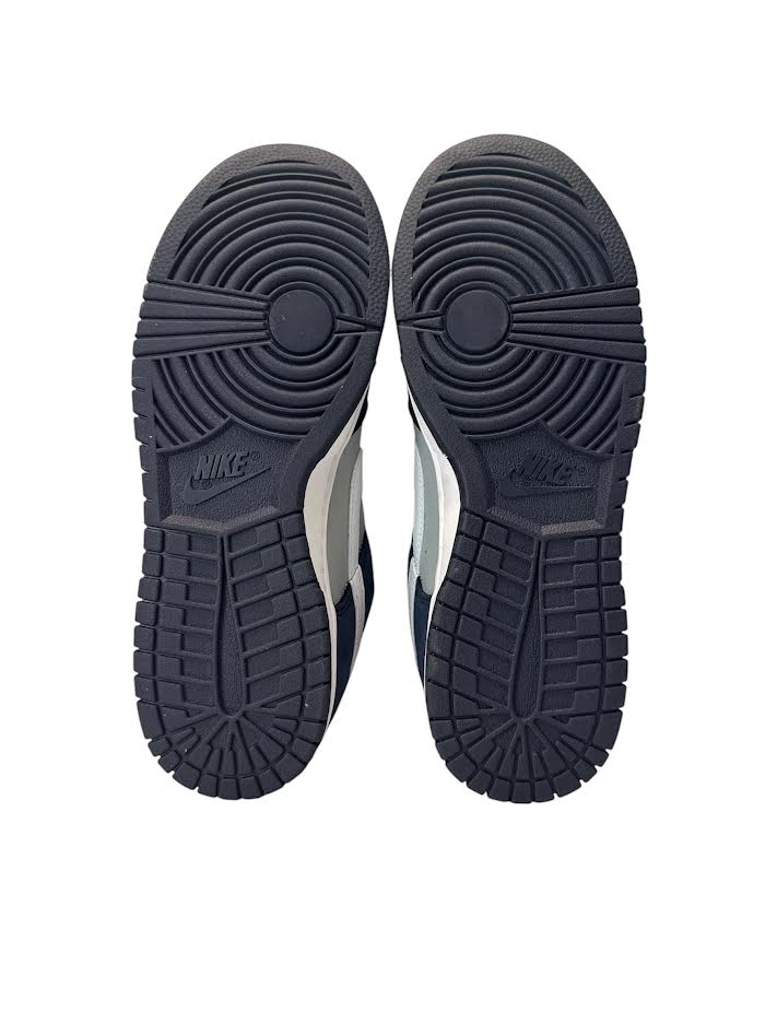 Black Nike sneakers shown from the sole on a white background