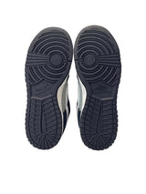 Black Nike sneakers shown from the sole on a white background