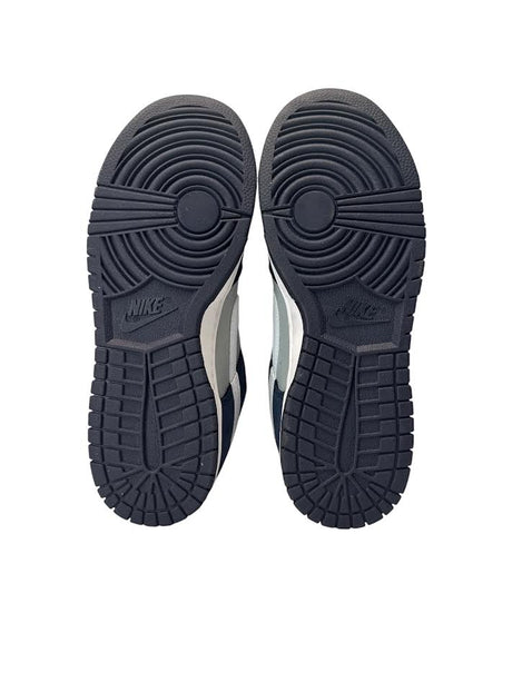 Black Nike sneakers shown from the sole on a white background