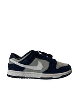 Navy and gray sneaker with Nike logo on a white background