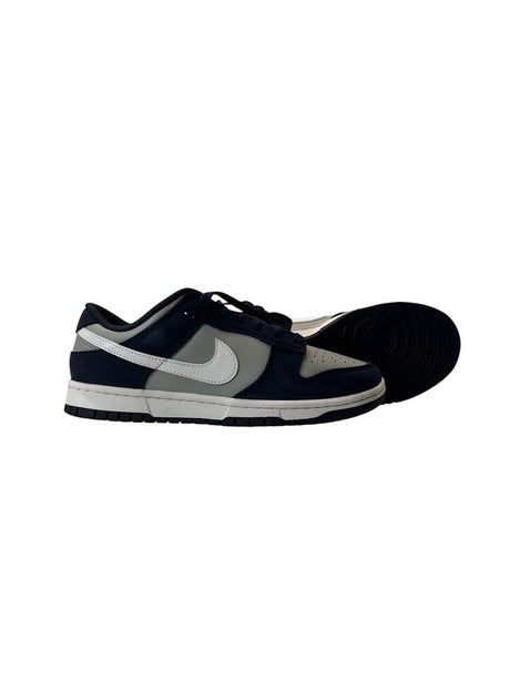 Navy blue and gray sneaker with a visible brand logo on a white background