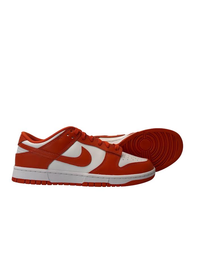 Orange and white sneaker with a visible brand logo on a white background