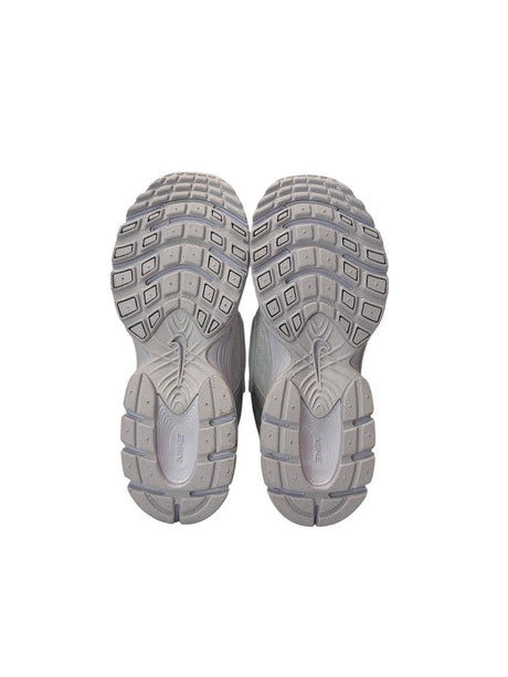Pair of gray athletic shoes with tread pattern on a white background