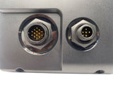 Close-up of a metallic device with two circular connectors on a white background