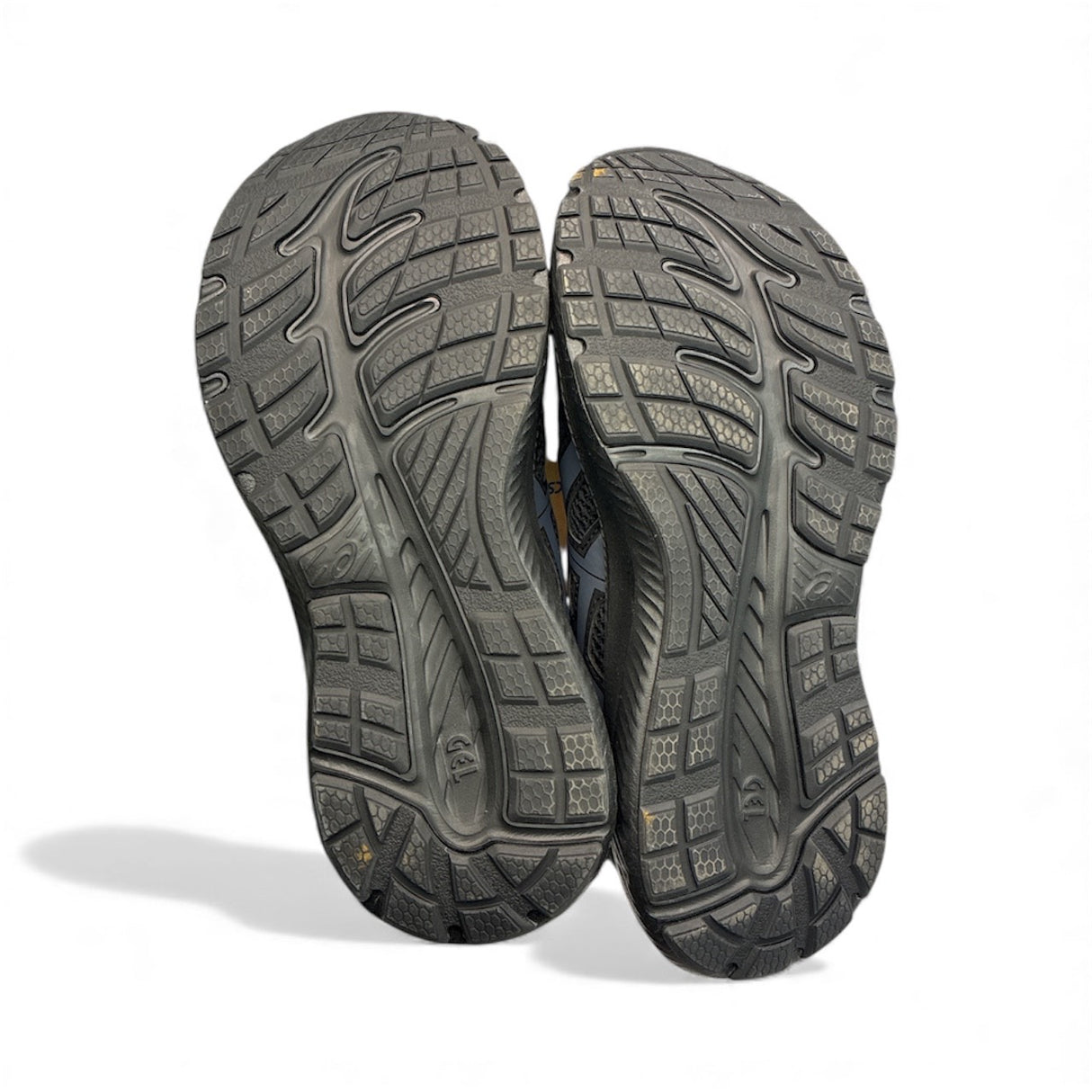 Close-up of a pair of gray hiking shoes with tread pattern on a white background