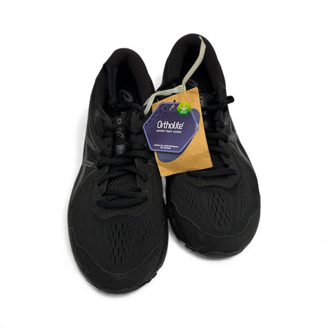 Pair of black running shoes with an Ortholite tag on a white background