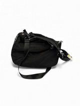 Side view of quilted black crossbody bag with adjustable strap