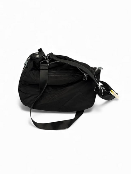 Side view of quilted black crossbody bag with adjustable strap