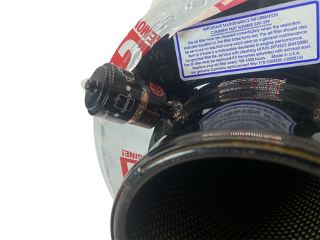 Close-up of a car exhaust system with visible brand logos on a white background